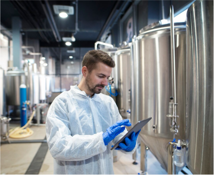 a_man_in_a_lab_coat_holds_a_tablet